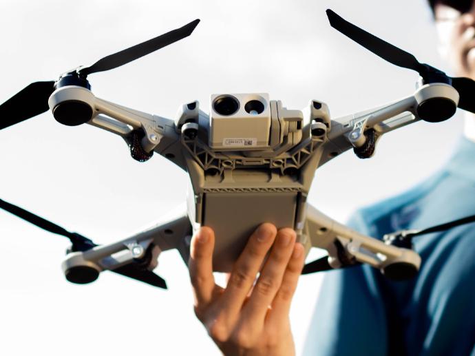 An American made Teal two drone being held by drone pilot.