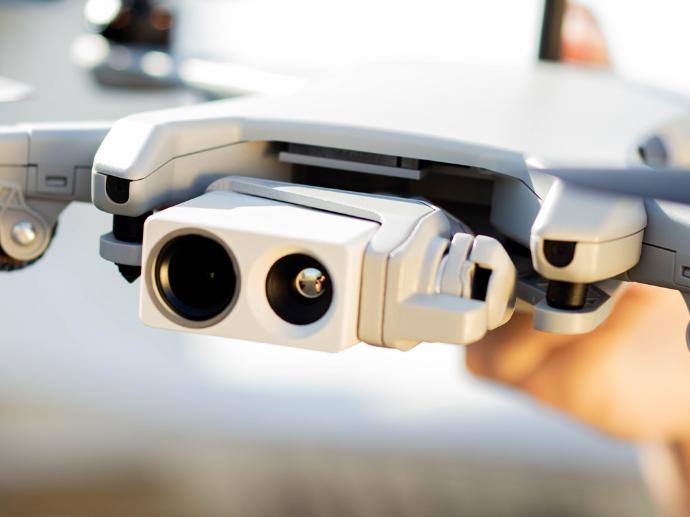 Thermal drone with sensors being held by drone pilot.