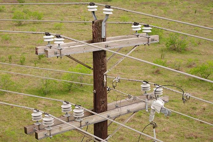 Aerial drone image of power distribution lines.