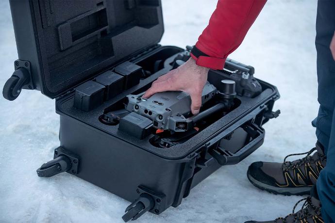 Search and rescue worker prepares DJI M30T drone for flight.