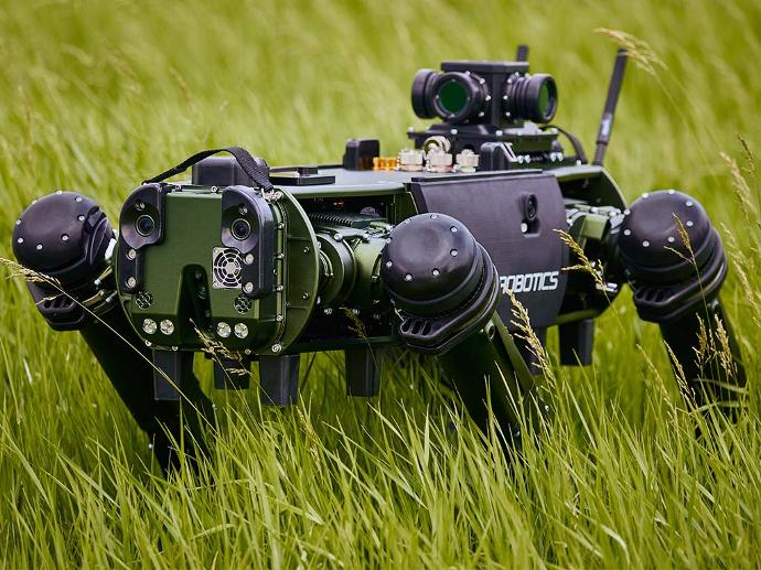 Quadruped robot in the field with sensors deployed.